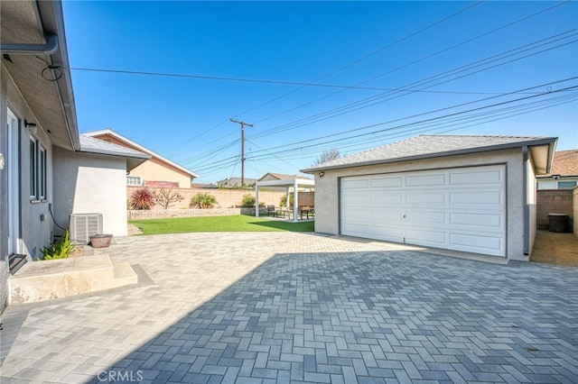 garage featuring cooling unit and a yard