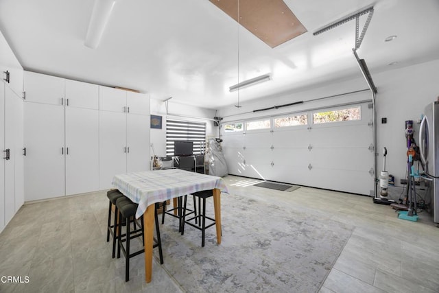 garage with stainless steel refrigerator