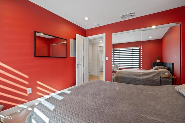 bedroom with a closet and hardwood / wood-style flooring