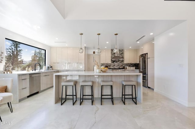 kitchen with pendant lighting, a breakfast bar area, a spacious island, and appliances with stainless steel finishes