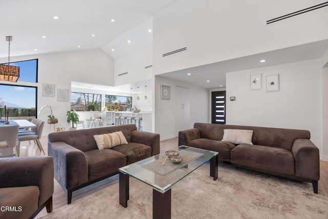 living room featuring high vaulted ceiling