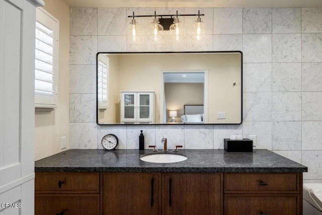 bathroom with vanity and tasteful backsplash