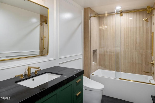 full bathroom featuring bath / shower combo with glass door, toilet, and vanity