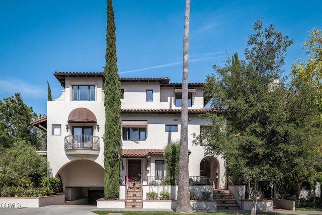 mediterranean / spanish house featuring a balcony