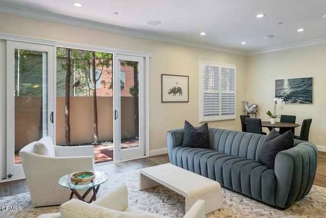 living room featuring light wood-type flooring and ornamental molding