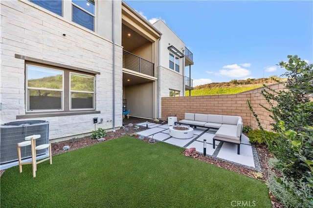 view of yard featuring central AC unit, a patio, and an outdoor living space with a fire pit