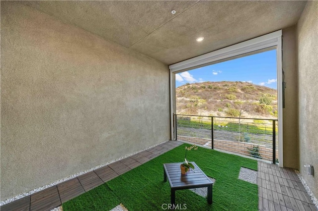 unfurnished sunroom featuring a mountain view