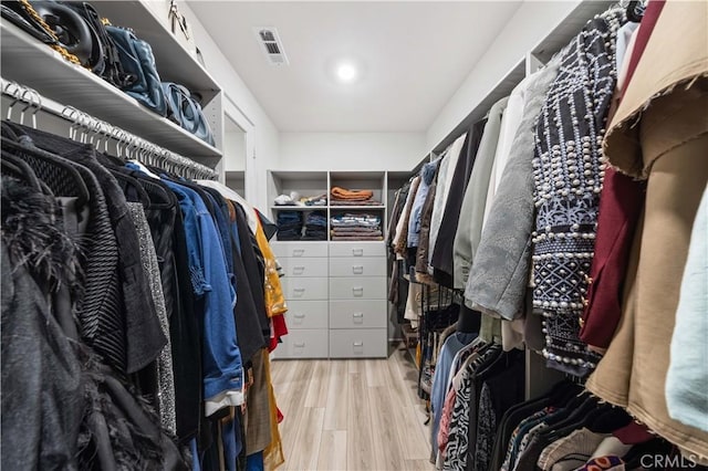 walk in closet featuring light hardwood / wood-style flooring