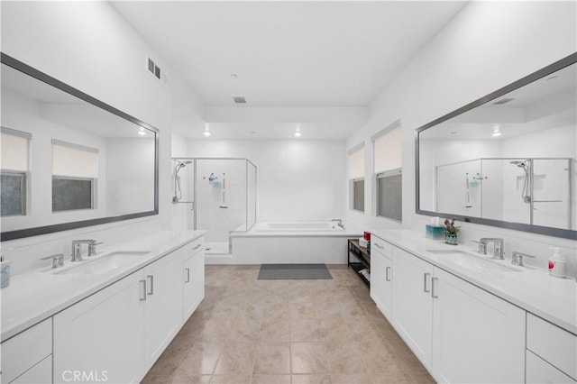 bathroom featuring independent shower and bath, tile patterned flooring, and vanity