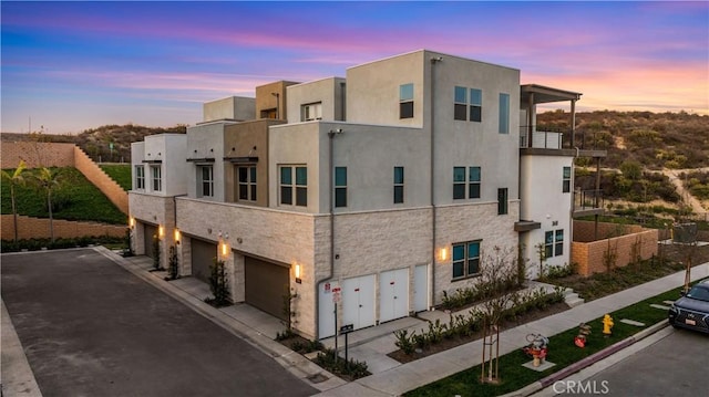 outdoor building at dusk with a garage