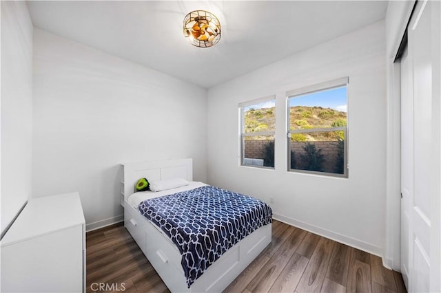 bedroom with dark wood-type flooring