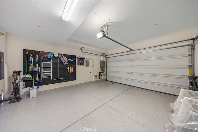 garage with water heater and a garage door opener