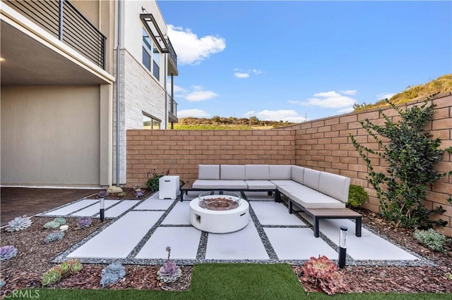 view of patio / terrace with an outdoor living space with a fire pit