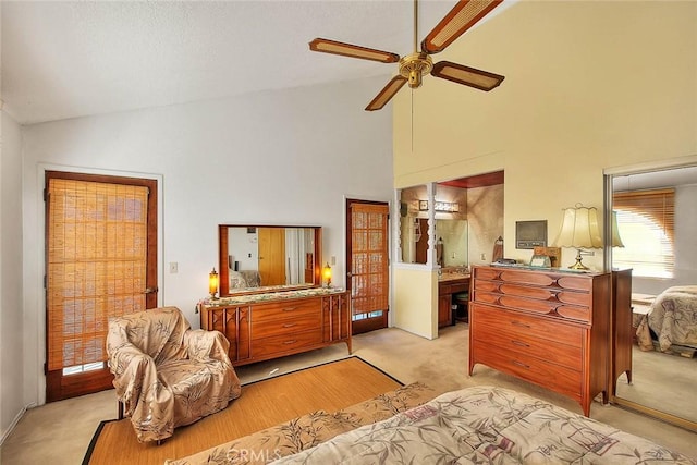 carpeted bedroom featuring connected bathroom, high vaulted ceiling, and ceiling fan