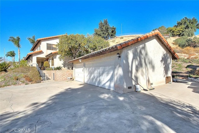 view of side of property featuring a garage