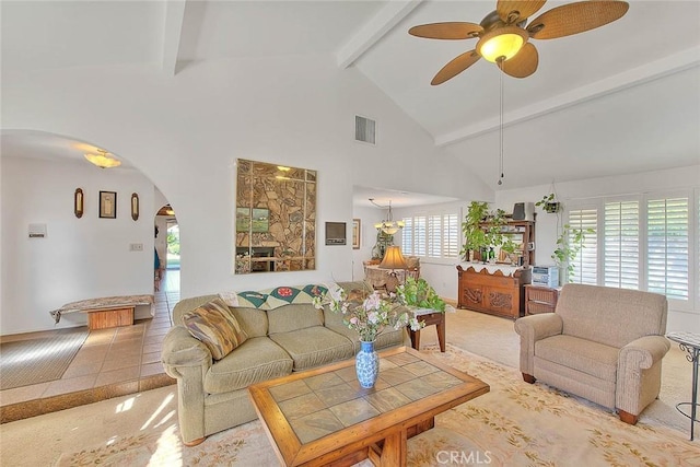 carpeted living room with high vaulted ceiling, ceiling fan, and beamed ceiling