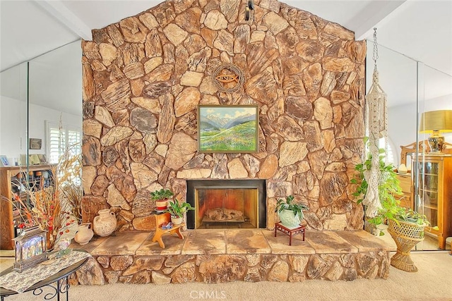 room details featuring a fireplace, beamed ceiling, and carpet flooring