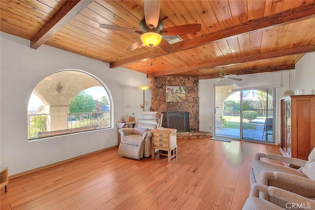 living room featuring a healthy amount of sunlight, light hardwood / wood-style flooring, beamed ceiling, and wood ceiling