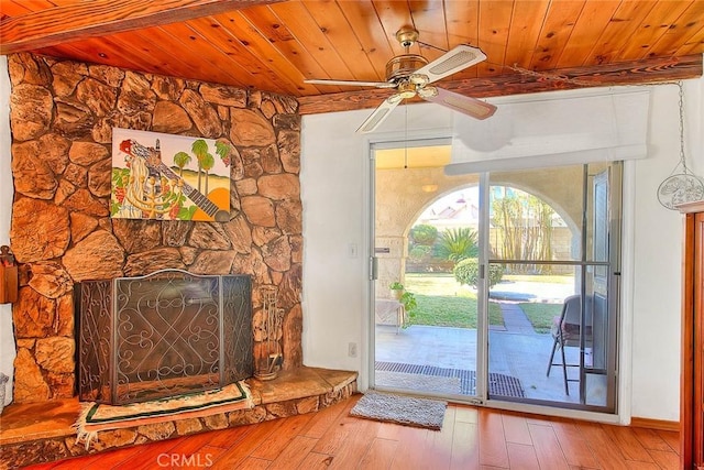 entryway with a fireplace, wooden ceiling, hardwood / wood-style floors, and ceiling fan