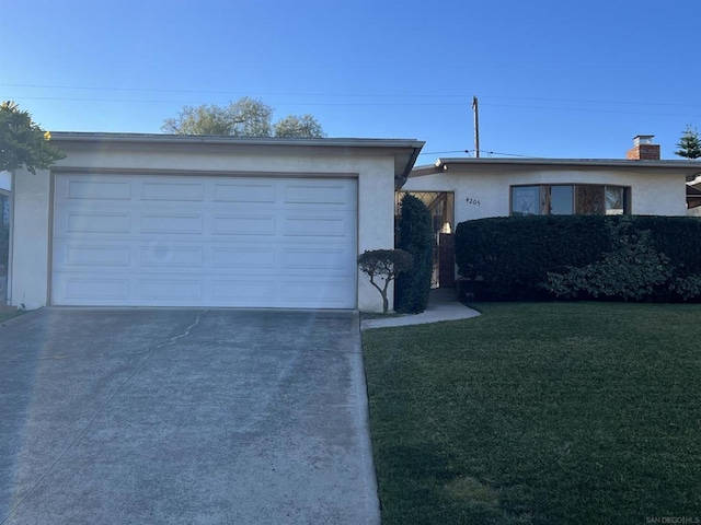 single story home featuring a garage and a front lawn