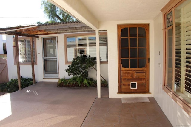 property entrance featuring a patio area