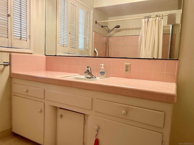 bathroom featuring vanity, backsplash, and a shower with curtain