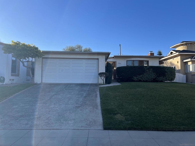 ranch-style house featuring a garage and a front lawn