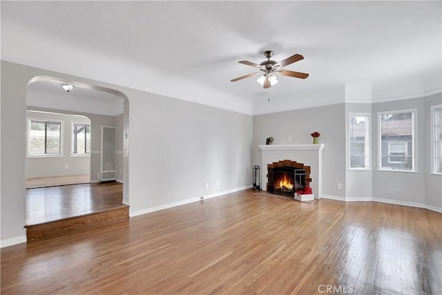 unfurnished living room with hardwood / wood-style flooring and ceiling fan