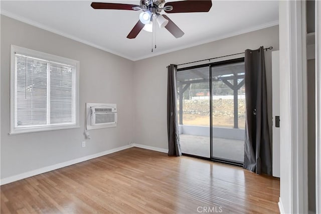 spare room with light hardwood / wood-style floors, an AC wall unit, crown molding, and ceiling fan