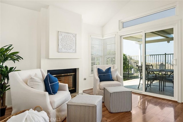 sitting room featuring vaulted ceiling and hardwood / wood-style floors