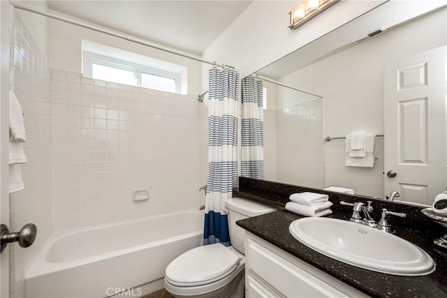 full bathroom with toilet, vanity, and shower / bathtub combination with curtain