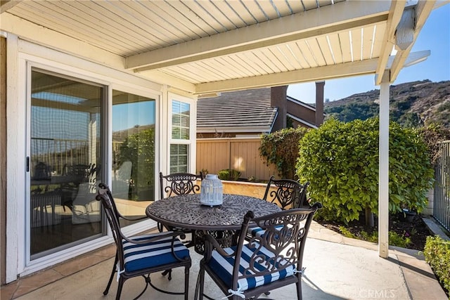 sunroom with a mountain view and beamed ceiling