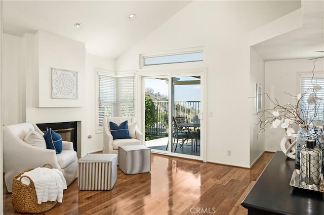 sitting room with vaulted ceiling and hardwood / wood-style floors