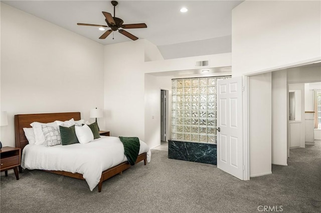 carpeted bedroom with ceiling fan and vaulted ceiling