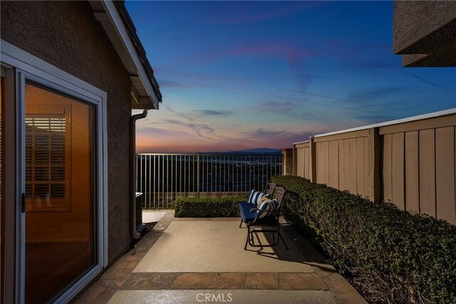 view of patio terrace at dusk