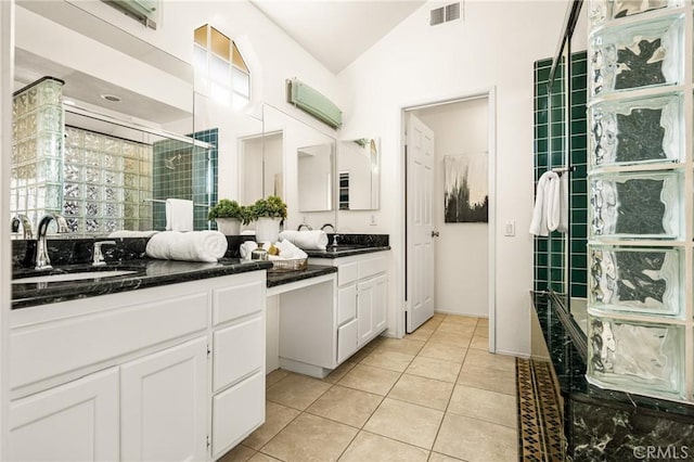 bathroom with an AC wall unit, lofted ceiling, tile patterned flooring, vanity, and walk in shower