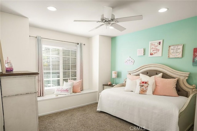 carpeted bedroom featuring ceiling fan and multiple windows