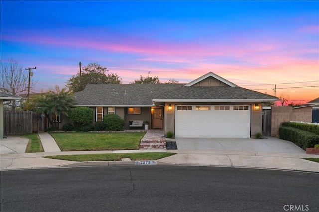 single story home with a garage and a lawn