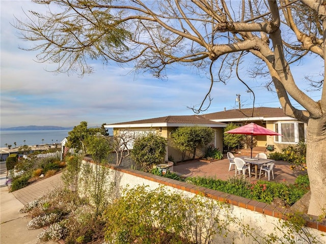 view of yard with a water view and a patio area