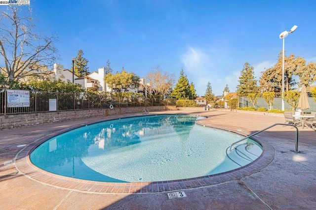 view of swimming pool featuring a patio area