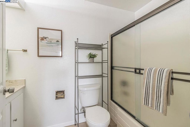 full bathroom with bath / shower combo with glass door, toilet, and vanity