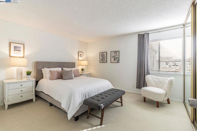 carpeted bedroom featuring a textured ceiling