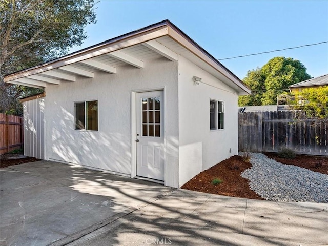 view of outbuilding with fence