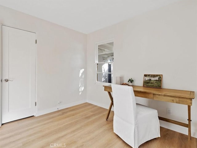 home office featuring baseboards and light wood-style floors