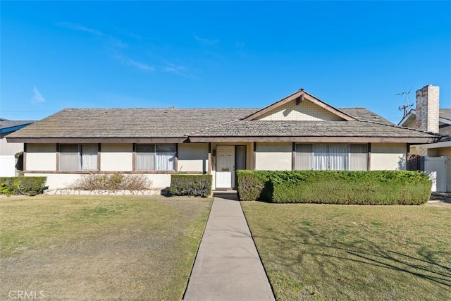 ranch-style house with a front lawn