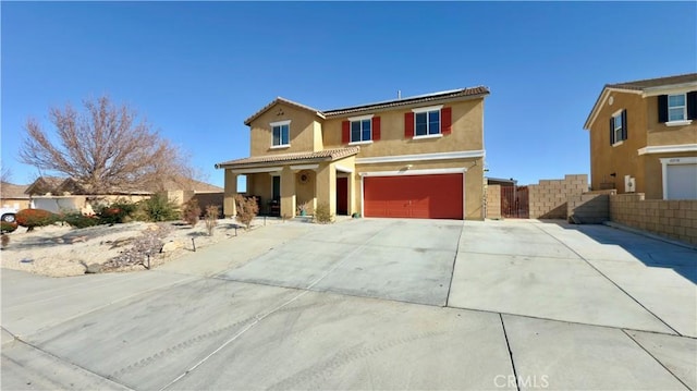 view of property featuring a garage and solar panels