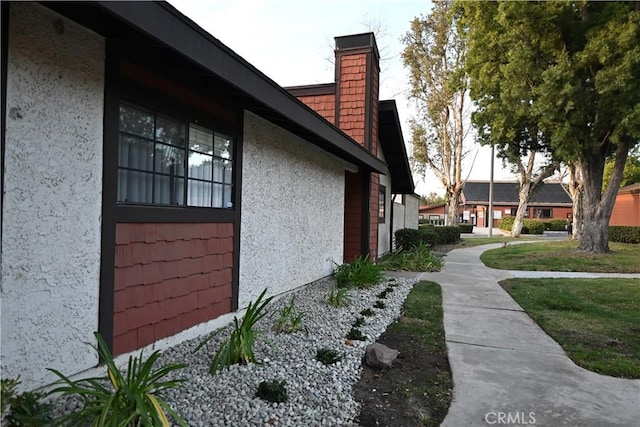 view of side of home with a lawn