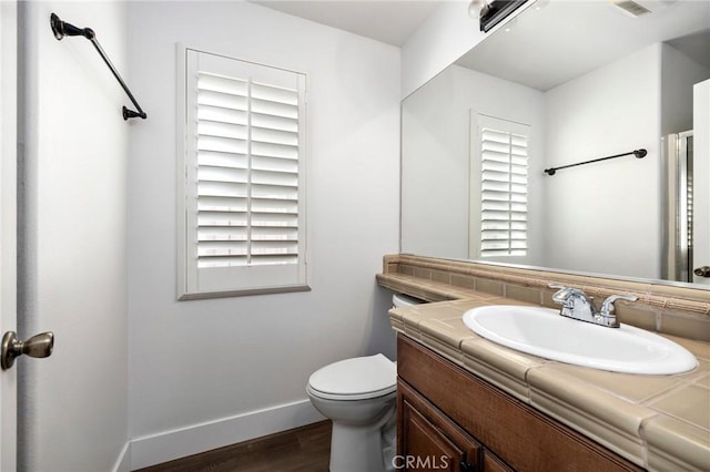 bathroom featuring vanity, hardwood / wood-style floors, and toilet