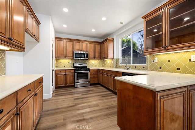 kitchen featuring hardwood / wood-style flooring, stainless steel appliances, and sink