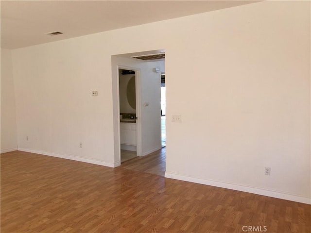 spare room with wood-type flooring